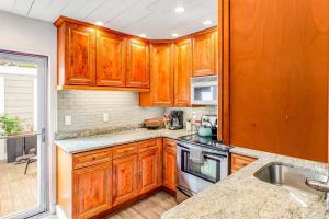 a kitchen with wooden cabinets and a sink at Lewes --- 6 Pilot Point in Lewes