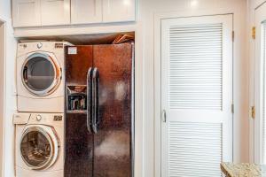 a kitchen with a refrigerator and a washer and dryer at Lewes --- 6 Pilot Point in Lewes +15 photos