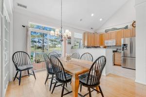 a kitchen and dining room with a wooden table and chairs at Bear Trap Dunes - 60 Willow Oak in Ocean View