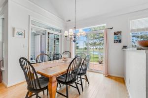 a dining room with a wooden table and chairs at Bear Trap Dunes - 60 Willow Oak in Ocean View +42 photos