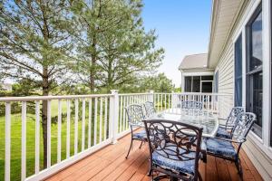 a patio with a table and chairs on a deck at Bear Trap Dunes --- 83F October Glory Dunes in Ocean View