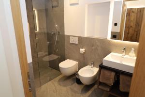 a bathroom with a toilet and a sink and a shower at Apartments Silvonia in Pallua +25 photos