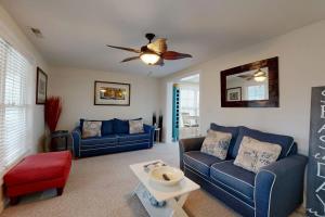 a living room with two blue couches and a ceiling fan at West Fenwick --- 39110 Van Buren Ave in Selbyville