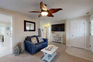 a living room with a blue couch and a ceiling fan at West Fenwick --- 39110 Van Buren Ave in Selbyville