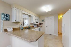 a kitchen with white cabinets and a counter top at West Fenwick --- 39110 Van Buren Ave in Selbyville