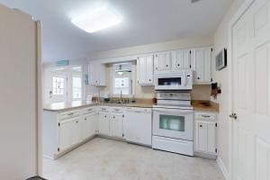 a kitchen with white cabinets and white appliances at West Fenwick --- 39110 Van Buren Ave in Selbyville +20 photos