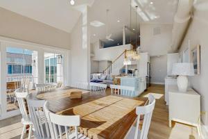 a kitchen and dining room with a wooden table and chairs at South Bethany --- 102 Brandywine Dr in Bethany Beach