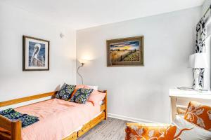 a small bedroom with a bed and a chair at Sea Colony - 903 Singles Ct in Bethany Beach +47 photos