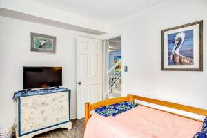 a bedroom with a bed and a tv and a dresser at Sea Colony - 903 Singles Ct in Bethany Beach