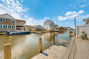 a boat is docked at a dock next to houses at Edgewater Acres --- 39157 Garfield Ave in Selbyville
