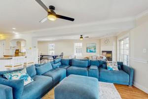 a living room with a blue couch and a kitchen at Edgewater Acres --- 39157 Garfield Ave in Selbyville