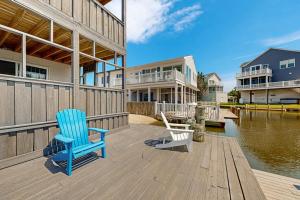 two chairs sitting on a wooden deck next to the water at Edgewater Acres --- 39157 Garfield Ave in Selbyville