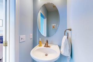 a bathroom with a white sink and a mirror at Bayside at Bethany Lakes #143 in Ocean View