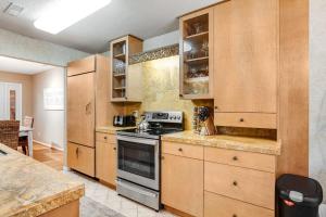 a kitchen with wooden cabinets and a stove top oven at Sea Colony - 52028 Canal Ct in Bethany Beach
