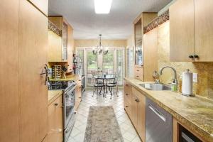a large kitchen with a sink and a table at Sea Colony - 52028 Canal Ct in Bethany Beach