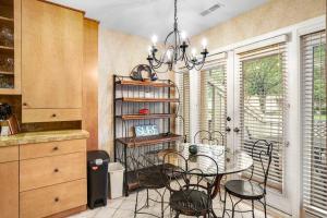 a kitchen with a table and chairs and a chandelier at Sea Colony - 52028 Canal Ct in Bethany Beach