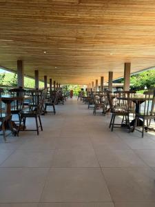 a row of tables and chairs under a pavilion at Flat Monte Castelo in Sairé