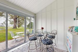 a patio with a table and chairs on a porch at Mallard Lakes - 142 Cardinal in Selbyville
