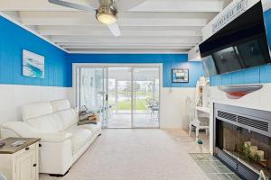 a living room with a white couch and a fireplace at Mallard Lakes - 142 Cardinal in Selbyville