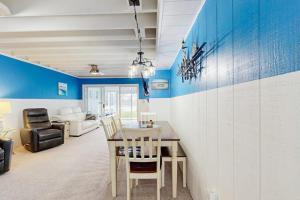 a dining room with blue walls and a table and chairs at Mallard Lakes - 142 Cardinal in Selbyville