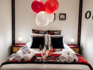 a bedroom with a bed with balloons on it at Hartbeespoort - El-Tsuri Guest Resort in Hartbeespoort