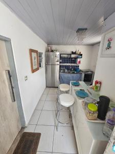 a small kitchen with a counter and a refrigerator at Condomínio top in São Paulo