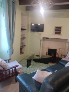 a living room with a couch and a fireplace at Chez Pépé in Limalonges
