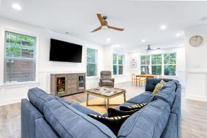 a living room with a blue couch and a tv at Bethany West --- 557 Fairway in Bethany Beach