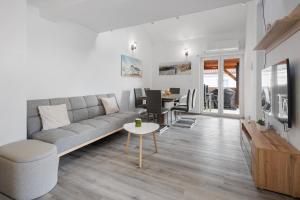 a living room with a couch and a table at Apartmani Rialto in Kakma