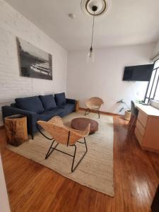 a living room with a blue couch and a table at Casa Alfredo in Mexico City