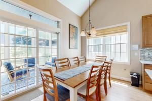 a kitchen and dining room with a table and chairs at Bear Trap Dunes - 67 Willow Oak in Ocean View