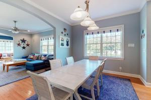 a dining room and living room with a table and chairs at Bayside Resort - 36486 Wild Rose in Selbyville