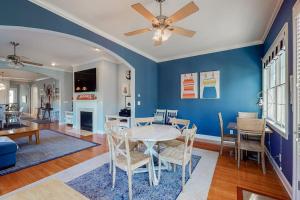 a dining room with blue walls and a table and chairs at Bayside Resort - 36486 Wild Rose in Selbyville