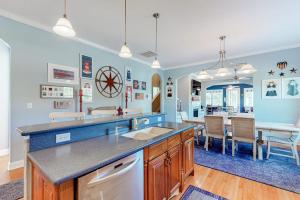 a kitchen and dining room with a dining table at Bayside Resort - 36486 Wild Rose in Selbyville +33 photos