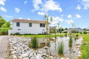 a home with a pond in front of a house at Fenwick Island -- 28 High Tide in Fenwick Island