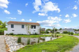 a house with a pond in front of it at Fenwick Island -- 28 High Tide in Fenwick Island