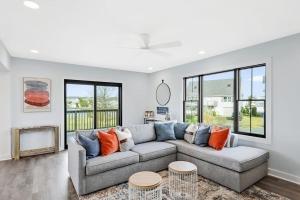 a living room with a couch and some windows at Fenwick Island -- 28 High Tide in Fenwick Island +37 photos