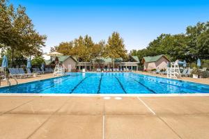 a large swimming pool with chairs and umbrellas at Bear Trap Dunes - 91 Willow Oak in Ocean View