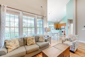 a living room with a couch and a table at Bear Trap Dunes - 91 Willow Oak in Ocean View