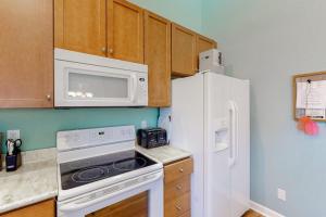 a kitchen with a white refrigerator and a microwave at Bear Trap Dunes - 91 Willow Oak in Ocean View +38 photos