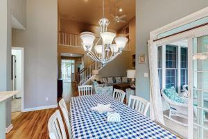 a dining room with a blue and white table and chairs at Bear Trap Dunes - 91 Willow Oak in Ocean View