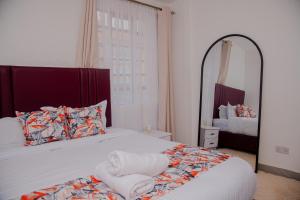 a bedroom with a bed and a large mirror at Parma Staycation in Rungiri