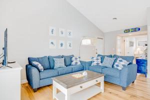 a living room with two blue couches and a coffee table at Sea Colony - 6301 Private in Bethany Beach