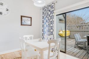 a white dining room with a white table and chairs at Sea Colony - 6301 Private in Bethany Beach