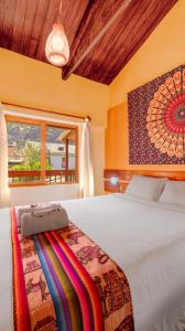 a bedroom with a large bed and a window at Hospedaje Chaska Pisac in Pisac