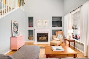 a living room with a fireplace and a table at Bear Trap Dunes 16 Sycamore St in Ocean View