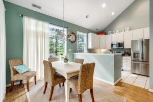 a kitchen with a table and chairs in a room at Bear Trap Dunes 16 Sycamore St in Ocean View