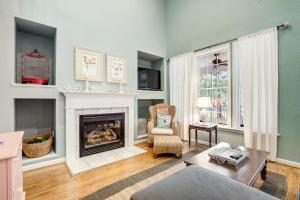 a living room with a fireplace and a chair at Bear Trap Dunes 16 Sycamore St in Ocean View
