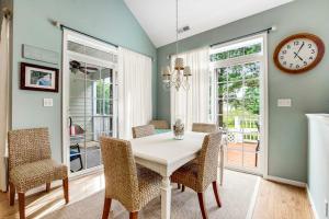 a dining room with a table and chairs and a clock at Bear Trap Dunes 16 Sycamore St in Ocean View +27 photos