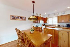 a kitchen with a wooden table and wooden chairs at Sea Colony --- 2203 Round Robin in Bethany Beach